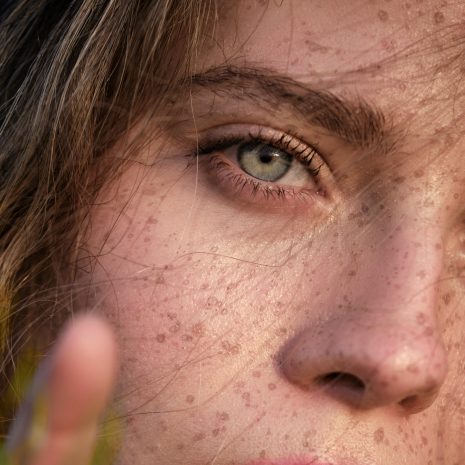 Crop attractive woman with freckles looking at camera